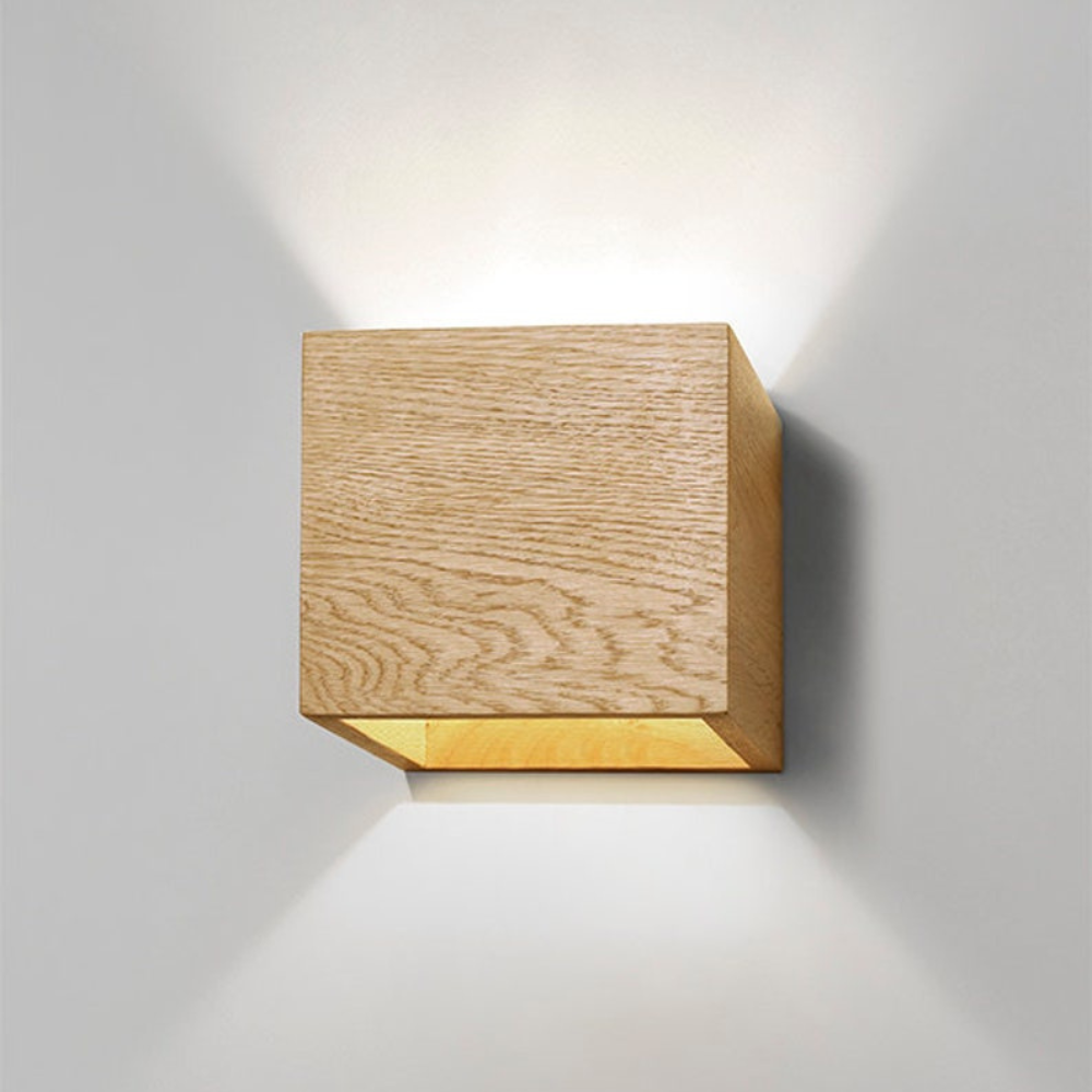 Bringen Sie einen Hauch von natürlicher Eleganz in Ihren Raum mit dieser modernen Wandleuchte aus Holz. Mit ihrem schlanken Würfeldesign unterstreicht sie die Schönheit der natürlichen Holzmaserung und spendet sowohl nach oben als auch nach unten gerichtetes Licht für ein sanftes, stimmungsvolles Leuchten. Diese minimalistische Leuchte eignet sich perfekt für Flure, Wohnzimmer, Schlafzimmer oder Leseecken und fügt sich nahtlos in moderne, skandinavische oder rustikale Einrichtungen ein. Die aus umweltfreund